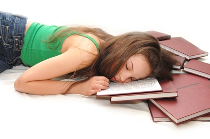 girl sleeping with her head on an open book