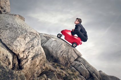 BE man in tiny car going up mountain DP