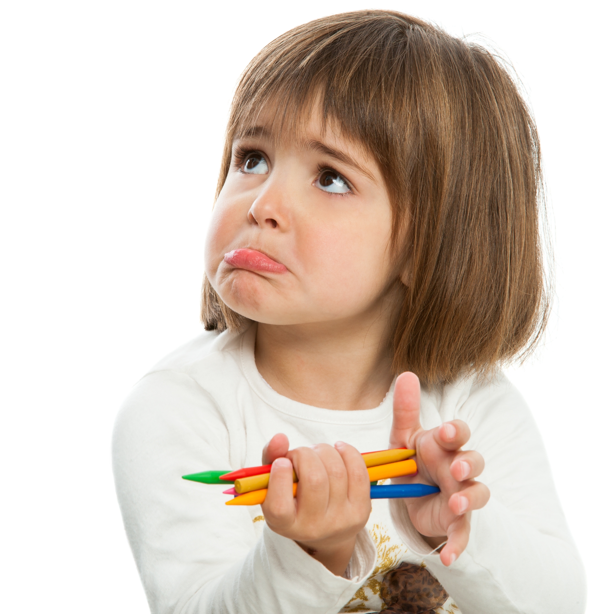 Unhappy little girl with crayons.